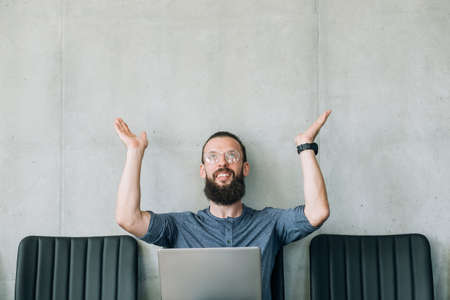 smiling man raising hands up job candidate and business recruitment concept. empty space for text.