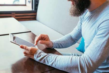 man holding tablet. mobility and online internet access through digital devices.の写真素材