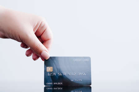 online payments made easy with credit card. personal finances and money management. hand holding bank card.の写真素材