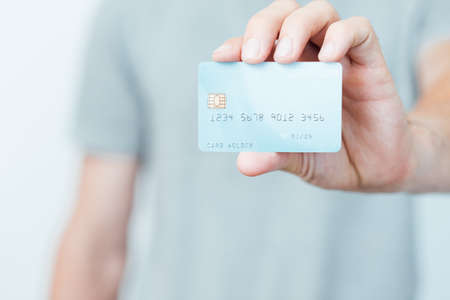 secure online payments with credit card. personal finances and bank account management. man holding plastic card.の写真素材