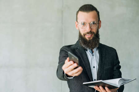 business communication training course. man offering mobile phone to talkの写真素材