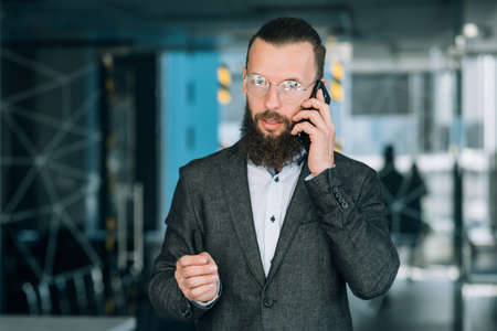 business conversation over the phone. man talking on his mobile.の写真素材