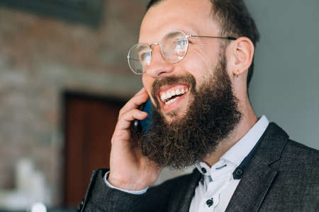 smiling man talking on the phone. communication and successful business dealsの写真素材