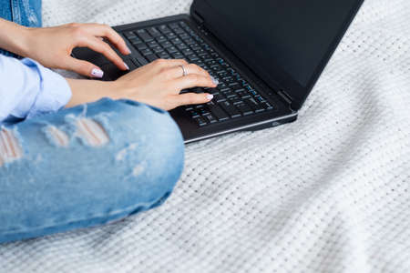 woman typing on laptop. online income. work on the internet and earn money from home.の写真素材