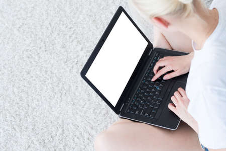 woman typing on laptop. blogger and social media. empty white screen for advertising.