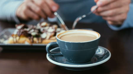 coffee in a cup and pastry. food habits. traditional drink and dessert.