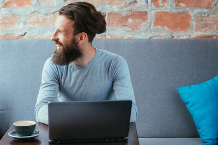 freelance content writer working in cafe using laptop.の写真素材