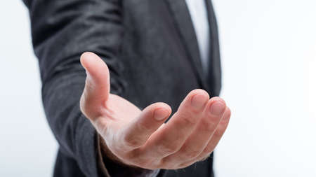 business man holding invisible object in palm of hand. work result virtual projection. product...