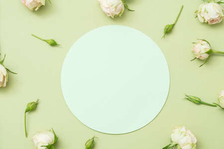 Womens day card mockup. Blank paper circle on palegreen background. Flower decor.の写真素材