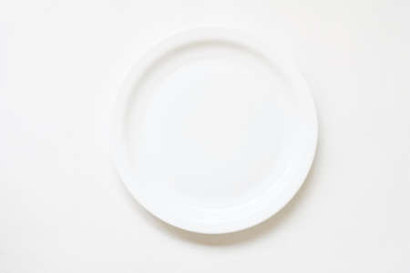Porcelain tableware. China art. Empty round plate mockup on white background. Flat lay.