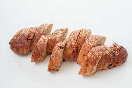 Healthy home made nutrition. Wholegrain bread bakery. Slices on white background.