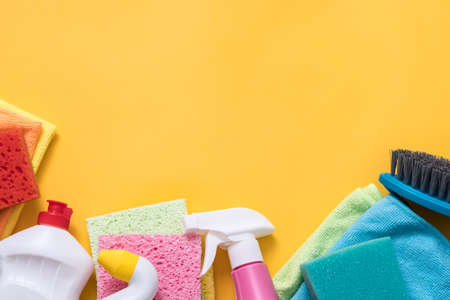 Disinfection concept. Cleaning supplies variety. Copy space on yellow background.