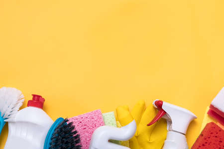 DIY home sanitizing. Basic household chemicals. Supplies assortment beneath copy space on yellow background.の写真素材