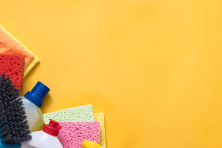 House cleaning supplies. Copy space on yellow background.の写真素材