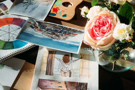 Artist workplace. Painter studio atmosphere. Watercolor artworks and flowers with art supplies...