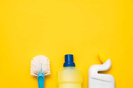 Toilet cleaning kit. DIY cleanup. Sanitary supplies beneath copy space on yellow background.の写真素材