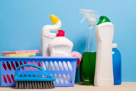 Home cleaning products background. Assorted variety of supplies on blue backdrop.の写真素材