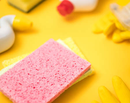 Cleaning supplies. Washing up. Assorted sponges on yellow background close up.