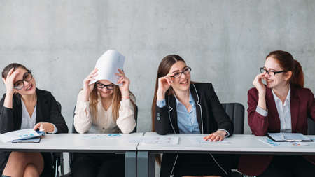 Interview failure. Rejection. Corporate committee females laughing at virtual job applicant.の写真素材