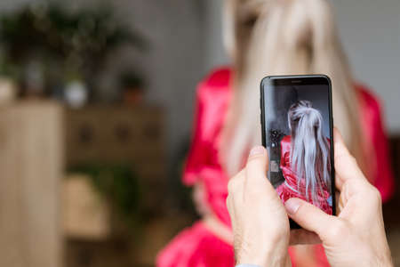 Happy newlyweds awake. New family morning. Mobile photo fun.の写真素材