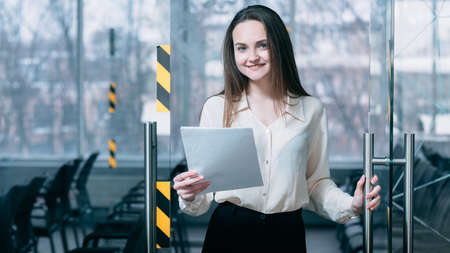 Welcome to job interview. We are hiring. Friendly corporate HR female opening office door for virtual applicant.の写真素材