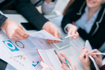 Sale analysis. Business meeting. Discussion and communication. Successful team analyzing diagrams and revenue documents.の写真素材