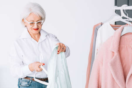 Smart senior lady wardrobe. Shopping leisure. Personal style of wealthy elderly woman.の写真素材