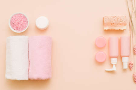 Spa treatment cosmetic products on coral pink background. Copy space for text.の写真素材