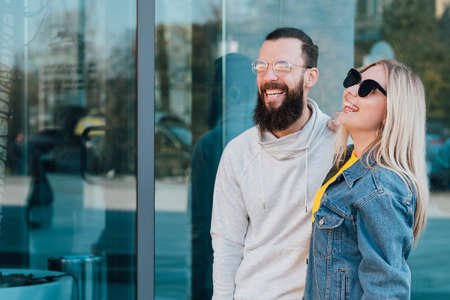 Casual young couple. Urban lifestyle. Smiling young man and woman. Copy space for advertising text.の写真素材