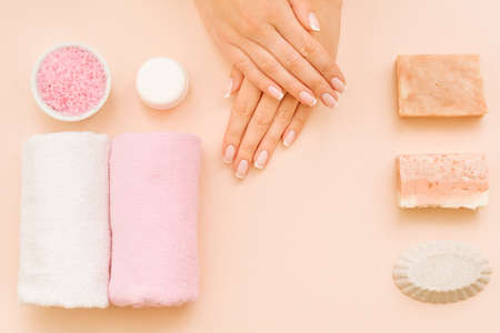 Woman hands beauty. Care and treatment cosmetic products. Copy space on coral pink background.の写真素材