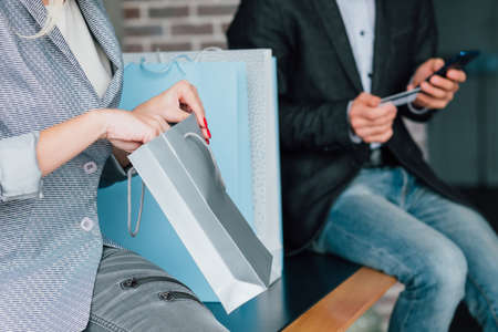 Mobile banking. Secure payment. Couple shopping with smartphone and credit card.