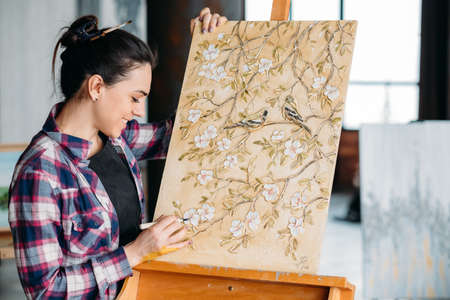 Creating floral pattern artwork. Artist talent and imagination. Woman painter with modeling tool....