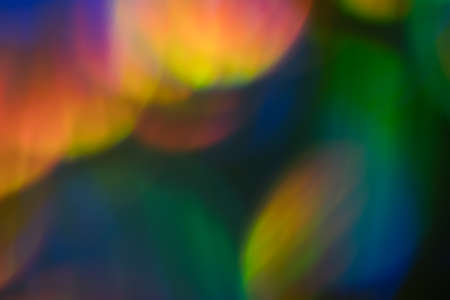 Blur colorful lens flare spots. Defocused abstract background. Bokeh Illuminated glow.の写真素材
