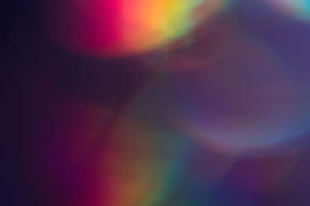 Purple bokeh dark spots. Faded colorful backdrop. Dark lens flare background.の写真素材