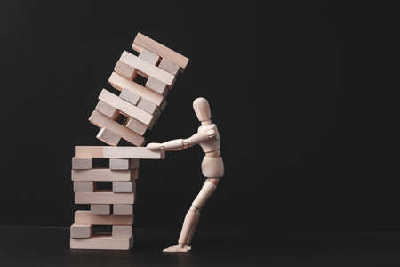 Business project. Strategy mistake. Risk and failure. Falling tower stack. Conceptual articulated mannequin composition.の写真素材