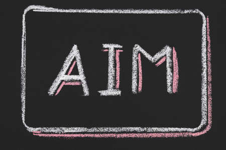 Ambitious plans. Successful strategy development. Aim word drawn in chalk on black background. Business aspiration.の写真素材