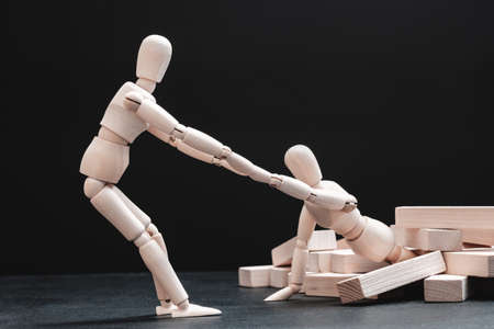 Personal encouragement. Mutual assistance and support. Helping hand. Team spirit. Corporate solidarity. Artist manikin compositionの写真素材