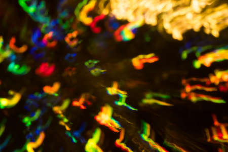 Blurred city night light reflection. Glowing multicolor spots. Bokeh lens flare effect.の写真素材