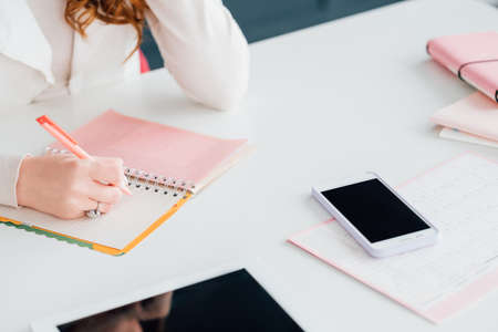 E-business startup. Project in progress. SMM woman setting objectives on agenda. Office and...