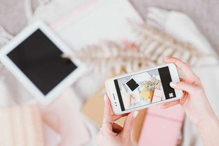 Blogging business. Digital lifestyle. Female taking smartphone photo. Creative influencer workplace....