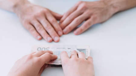 Financial support. Woman offers man money loan in cash. Business sponsorship and patronage.の写真素材