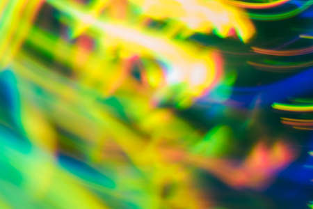 Blurred blue green lines on dark background. Neon lights in motion. Lens flare glow.の写真素材
