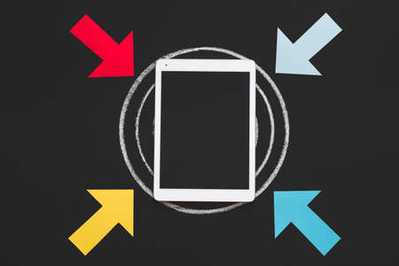 Technology and innovation in business planning and growth. Succeed with device. Arrows pointing at tablet on target.の写真素材