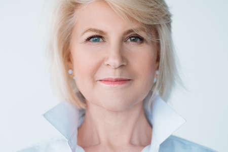 Senior woman beauty. Aged lady portrait. Female looking at camera. Natural makeup. Heterochromia. Facial expression.の写真素材