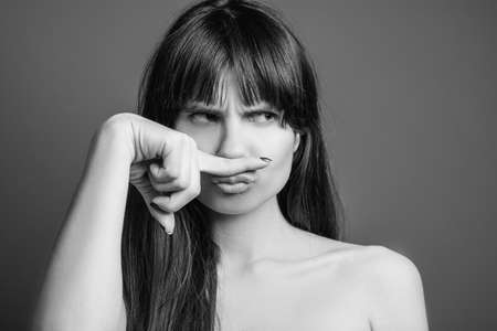 Rebellious beautiful young lady. Offended facial expression. Black and white closeup portrait of emotional woman.の写真素材