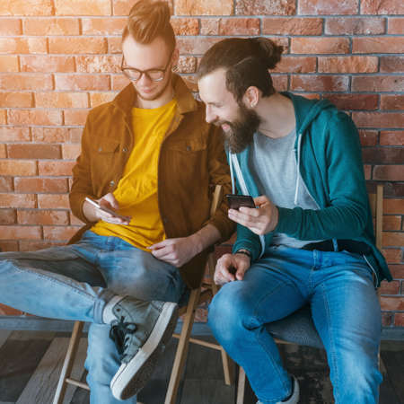Always connected. Social networking. Excited millennials with smartphones surfing, sharing. Digital...