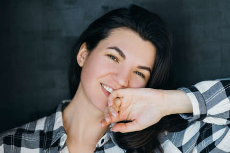 Young woman portrait. Relaxed posture. Happy and friendly beautiful brunette. Easygoing millennial...