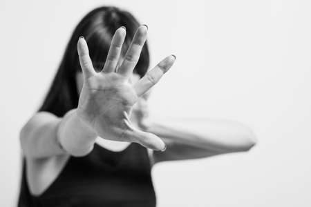 Stop violence. Refusal rejection and denial gesture. Black and white portrait of woman putting palm...