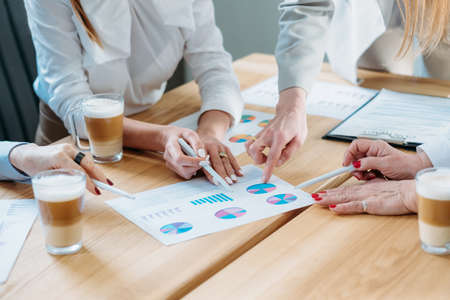 Business analysis. Project development. Cropped shot of successful women working with graphs, discussing strategy at meeting.の写真素材