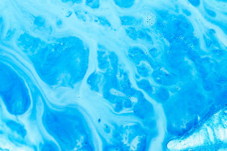 Abstract art texture background. Flowing emulsion design. Beautiful sky blue paint with bubbles and glitter.の写真素材